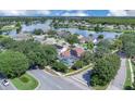 Aerial view showing the home's swimming pool and its proximity to a lake and neighborhood at 2402 Raven Croft Ct, Orlando, FL 32837