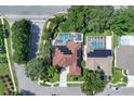 An aerial view of the property showcasing its pool, solar panels, and proximity to neighborhood streets at 2402 Raven Croft Ct, Orlando, FL 32837
