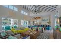 Open-concept clubhouse with soaring ceilings, modern decor, stylish furniture, and access to the pool at 2525 Shanti Dr, Kissimmee, FL 34746