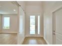 Bright foyer featuring wood-look flooring, and large windows with an interior view at 2673 Calistoga Ave, Kissimmee, FL 34741