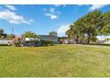 Beautiful single-story home featuring a lush green lawn and mature landscaping at 2830 W Oak St, Kissimmee, FL 34741