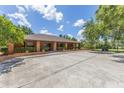 Expansive front view of a well-maintained brick home, showcasing its wide driveway and curb appeal on a sunny day at 3181 Canter Ln, Kissimmee, FL 34746