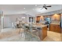 Bright kitchen with an island, granite countertops, a breakfast bar, stainless steel appliances, and modern finishes at 3181 Canter Ln, Kissimmee, FL 34746
