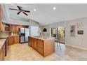 Beautiful kitchen with granite countertops, a center island, stainless steel appliances, and custom cabinetry at 3181 Canter Ln, Kissimmee, FL 34746