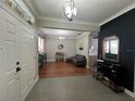 Inviting foyer showcasing tile floors, a stylish console, and an open floor plan into the home's living area at 3339 Primrose Willow Dr, St Cloud, FL 34773