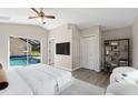 Spacious main bedroom featuring pool access, neutral decor, and an ensuite bathroom at 373 Shady Oak Loop, Davenport, FL 33896