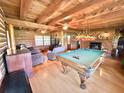Inviting living room boasting a pool table, fireplace, beamed ceilings, and comfortable seating at 4075 Packard Ave, St Cloud, FL 34772