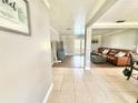 Spacious open-concept living area with tile floors and leather furniture at 4125 Packard Ave, St Cloud, FL 34772