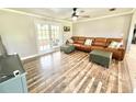 Bright living room featuring a comfortable leather sofa and hardwood floors at 4125 Packard Ave, St Cloud, FL 34772