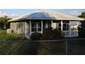 Charming single-story home featuring a metal roof and yard at 423 Midway Ave, Mascotte, FL 34753