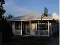 Quaint home with a metal roof, covered porch and yard at 423 Midway Ave, Mascotte, FL 34753