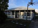 Quaint home with a metal roof, covered porch and yard at 423 Midway Ave, Mascotte, FL 34753