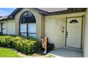 Close up front entrance of home with arched window and beautiful landscaping at 4830 Red Bay Dr, Orlando, FL 32829