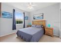 Bright bedroom with neutral colors, featuring a bed, and blue accents at 504 Terrace Ridge # 311, Davenport, FL 33896