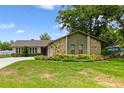 Charming single-story home featuring a stone facade, well-manicured lawn, and a long driveway at 6161 Bass Hwy, St Cloud, FL 34771