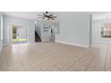 Open-concept living area featuring neutral tile flooring and ample natural light at 6905 Beargrass Rd, Harmony, FL 34773