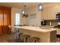 Modern kitchen with white countertops, stainless steel appliances, and stylish pendant lighting at 721 Benoi Dr, Davenport, FL 33896