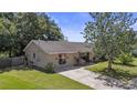 Lovely single-story home with a large front yard and charming exterior features at 8733 Catbriar Ln, Orlando, FL 32829