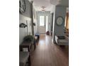 Inviting entryway with hardwood floors, bench seating, and stylish decor at 8986 Fullerwood Ave, Orlando, FL 32832
