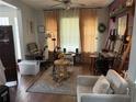 Bright living room with large windows, cozy seating, and a decorative rug at 8986 Fullerwood Ave, Orlando, FL 32832
