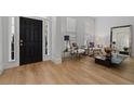 Stylish foyer featuring hardwood floors, a black front door, and elegant decor at 933 Jasmine St, Celebration, FL 34747