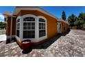 Home exterior featuring a brick driveway and bay windows at 10207 Cody Ln, Orlando, FL 32825
