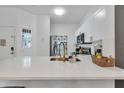 Bright, modern kitchen with white cabinets, quartz countertops, and gold hardware at 1129 Park Ridge Cir, Kissimmee, FL 34746