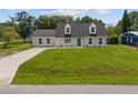 Inviting home boasts a lush green lawn and a symmetrical façade, enhancing its curb appeal at 1158 Stroupe Rd, Kissimmee, FL 34744