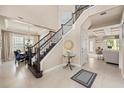 Elegant foyer with a staircase, tile flooring, and views into the dining room and living spaces at 1225 Radiant St, Reunion, FL 34747