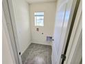 A cozy laundry room with a window for natural light at 1370 Holodak Dr, Davenport, FL 33837