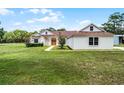 Beautiful home with meticulous lawn, complemented by mature trees and fresh landscaping at 1781 Terra Verde Ln, Chuluota, FL 32766