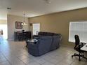 Spacious living room featuring neutral walls, tile floors, and comfortable seating with a dining area at 2106 Congress Ln, St Cloud, FL 34769