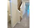 Bright entryway with tiled flooring, staircase, and convenient half bathroom at 2278 Tay Wes Dr, St Cloud, FL 34771