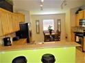 Cozy eat-in kitchen with wooden cabinets, stainless steel appliances, and decorative wall art at 2281 Royal Ridge Dr, Davenport, FL 33896