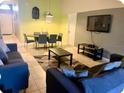 Open living space with tile floors, comfortable seating, and a modern dining area at 2281 Royal Ridge Dr, Davenport, FL 33896