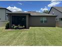 Spacious backyard with lush green grass and a screened in patio at 2436 Gratia Pl, Casselberry, FL 32707