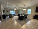 Open-concept living room with tile flooring, ceiling fan, and sliding glass doors to the backyard at 2436 Gratia Pl, Casselberry, FL 32707