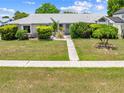 Charming single-story home with a well-maintained lawn and inviting walkway at 2637 Debany Rd, Kissimmee, FL 34744