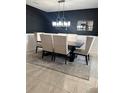 Elegant dining room with modern chandelier, sleek table and sophisticated decor at 293 Fiddlewood Ct, Davenport, FL 33837