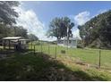 View of fenced in yard and home exterior with shed in background at 3050 Old Soldier Rd, Lakeland, FL 33810