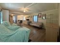 Open-concept living room with ceiling fan, wood laminate floors and neutral decor at 3050 Old Soldier Rd, Lakeland, FL 33810