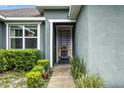 A close-up on a unique and colorful front door with tasteful landscaping in front of a well-maintained home at 3390 George Sauls St, Deltona, FL 32738