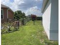 Backyard with a well-maintained lawn, chain-link fence, and some foliage at 343 Marquee Dr, Kissimmee, FL 34758