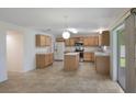 Open kitchen and breakfast nook with light wood cabinets, stainless appliances and natural light at 364 Fish Hawk Dr, Winter Haven, FL 33884