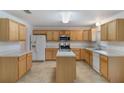 Bright kitchen featuring light wood cabinetry, a center island, and modern appliances at 364 Fish Hawk Dr, Winter Haven, FL 33884