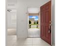 View from the entryway showcasing neutral tile, leading into a bright, open interior at 371 Pinecrest Loop, Davenport, FL 33837