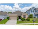 Single-story home showcasing manicured lawn, complemented by a two-car garage at 371 Pinecrest Loop, Davenport, FL 33837