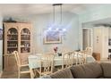 Bright dining area with a table, seating for eight, and decorative furnishings at 421 Bridle Path, Casselberry, FL 32707