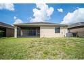 Large backyard with a screened lanai, green grass, and no rear neighbors offering privacy at 4928 Cortland Dr, Davenport, FL 33837