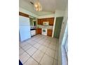 A spacious kitchen with a window and white appliances offer ample cooking and storage space at 5230 Clarion Oaks Dr, Orlando, FL 32808